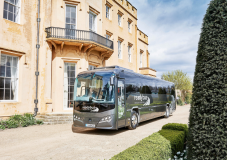 Readybus coach parked outside a historic building, providing safe, reliable school coach hire for educational trips and group travel.
