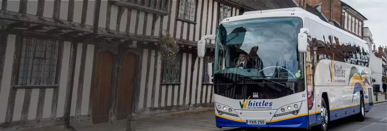 Whittles coach infront of Tudor house